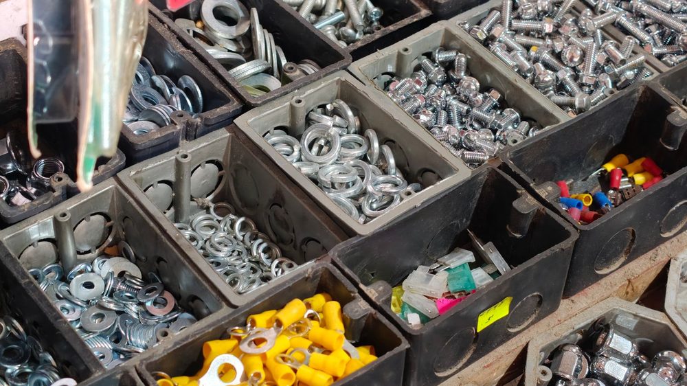 Industrial fasteners and hardware in storage bins (illustrative stock photo)