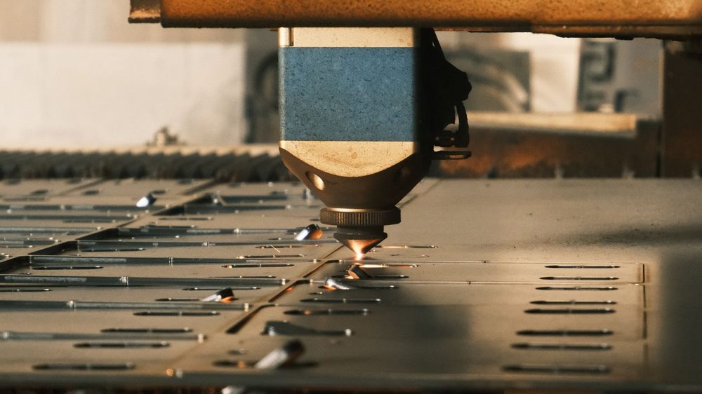 Laser cutting machine processing sheet metal (illustrative stock photo)