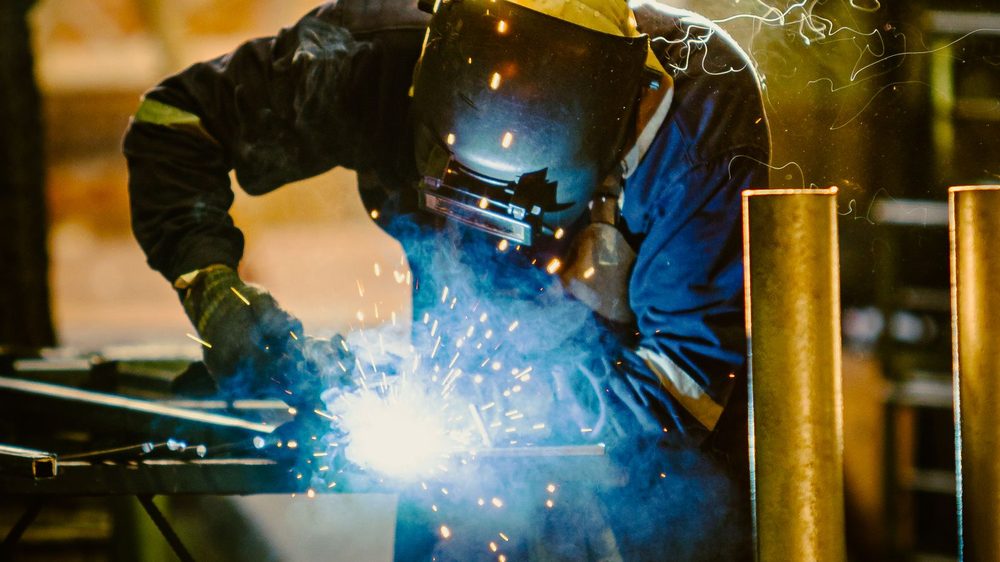 Welder at work in a fabrication workshop (illustrative stock photo)